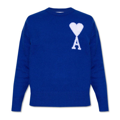 The Ami Paris Sweater in blue features a round neck, ribbed cuffs, and Parisian elegance with a white heart-shaped A on the upper left chest.